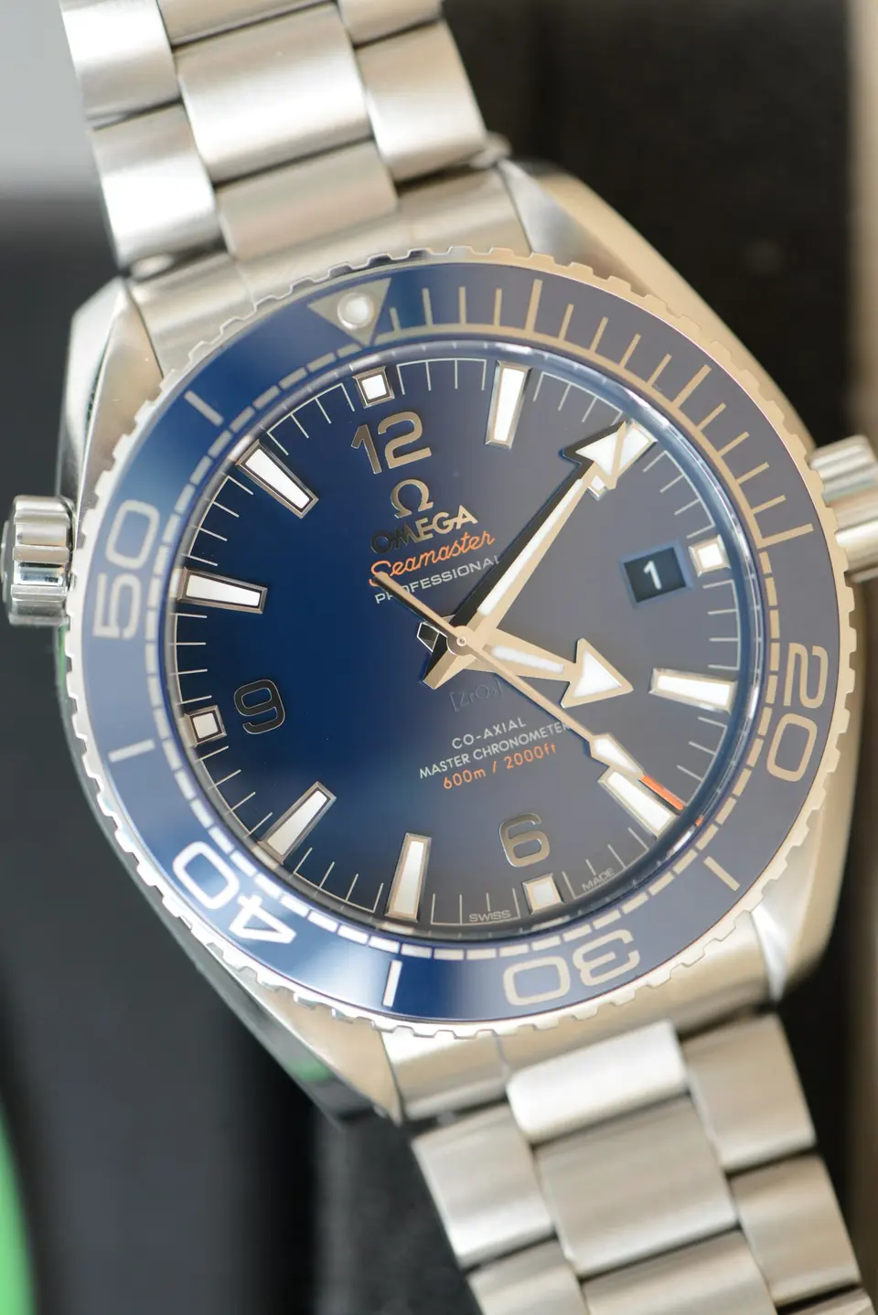 Blue-dial Omega Seamaster Planet Ocean 600M ref. 215.30.44.21.03.001 on a steel bracelet — stand-in photograph